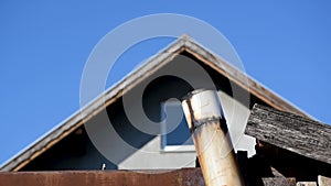 Hot and cool air mix and swirls above top of chimney or enamel flue pipe