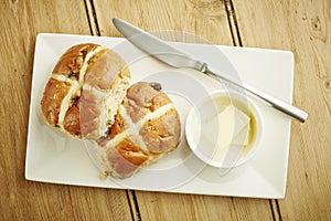 Hot cross bun on white dish photo