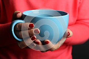 Hot cup of coffee in the women's hands