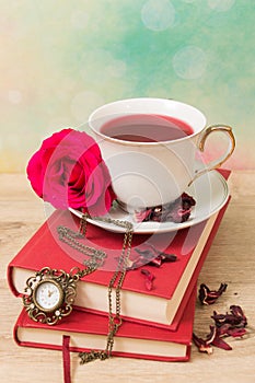 Hot cup of red tea and books