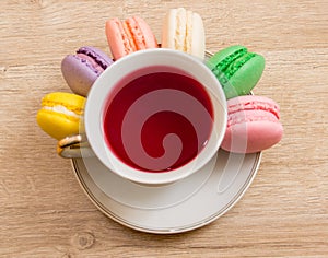 Hot cup of red tea colored cakes