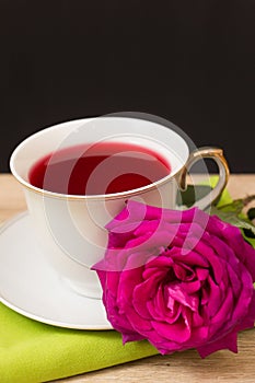 Hot cup of tea and pink flower