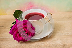 Hot cup of tea and pink flower