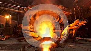Hot dark workshop of steel production in electric furnaces, with burning fire and smoke. Stock footage. Metallurgical