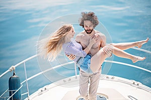 Hot dating lovers on the luxury boat in open sea in summer.