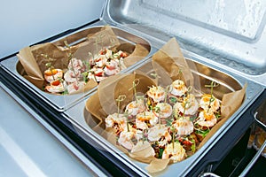Hot Delicates, appetizer canape with tiger shrimp, fused cheese and vegetables. Catering service.