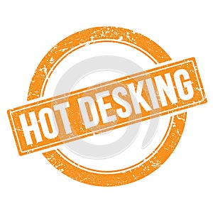 HOT DESKING text on orange grungy round stamp photo