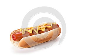 Hot dog - grilled sausage in a bun with sauces isolated on white background