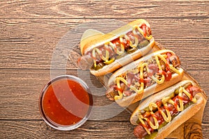Hot dog with grilled sausage  mustard  and ketchup  onions  and greens on paper background