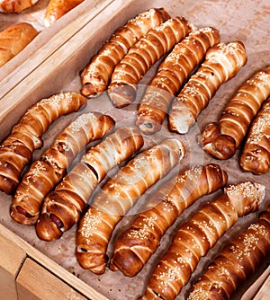 Hot dog with sesame seeds on shelf in Bakery shop