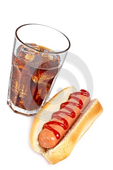 A hot dog and soda glass