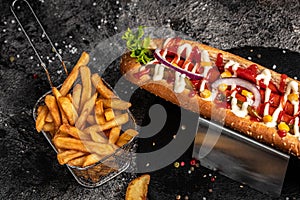 Hot dogs with different toppings on a dark background. Food background. fast food and junk food concept, Street food