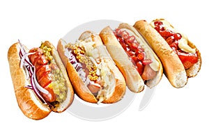 Hot dogs fully loaded with assorted toppings on a tray. Delicious hot-dogs with pork and beef sausages. Isolated on