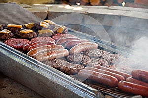 Hot dogs and hamburgers grilling on BBQ photo