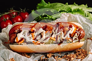 Hot dogs with ketchup, mustard and vegetables on wooden table