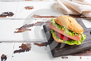 Hot dogs on a wooden Board. Hot dog with lettuce tomato and sausage. Copy space.