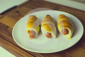 Hot dogs wrapped in baked pastry