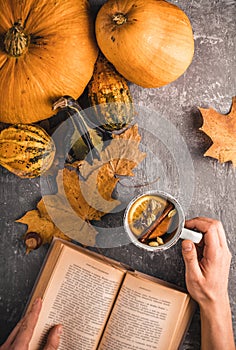 Hot drink and a book on the table in the autumn mood