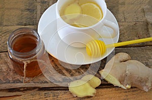 A hot drink for a cold. Autumn. disease. Health. Tea of lemon and ginger. Honey for treatment. Cup of green natural tea