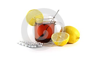 Hot drink with a lemon with drugs for colds and flu, isolated