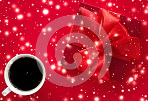 Winter holiday gift box, coffee cup and glowing snow on red flatlay background, Christmas time present surprise