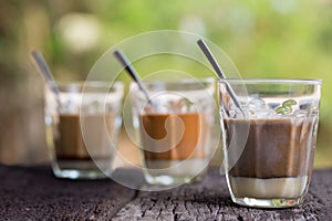 Hot drink thai milk tea, black coffee, cocoa signature local street beverage on wooden table