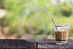 Hot drink thai milk tea signature local street beverage on wooden table