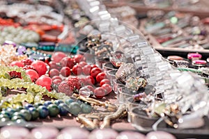 Hot of expensive gemstone jewelry. Rings, necklaces and bracelets made of peridot and azurite stones, red coral, sapphire, rose qu