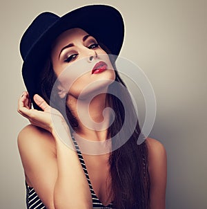 Hot female model with bright makeup and red lipstick in bla