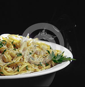 Hot Fettuccine in bowl, with black background photo