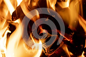 Hot fireplace full of wood. Real Flames from burning logs texture background. Fireplace background. Fire flame close up