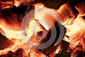 Hot fireplace full of wood. Real Flames from burning logs texture background. Fireplace background. Fire flame close up