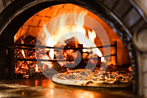 Hot Flames in Pizza Oven. Traditional Firewood Stone Wood Fired Pizza Oven