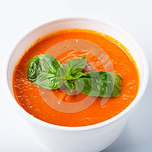 Hot food delivery - tomato gaspacho soup isolated