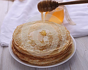 Hot and fragrant pancakes with honey