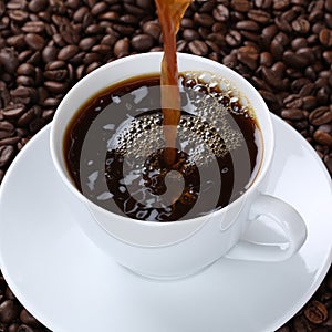 Hot fresh coffee pouring in cup
