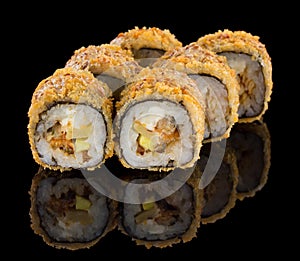 Hot Fried Futomaki Sushi roll with eel, avocado and cheese isolated on black background with reflection