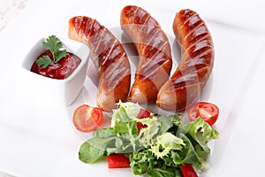 Hot and fried sausages with vegetables and spices