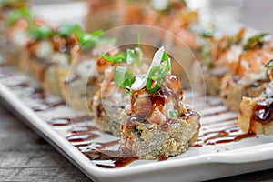 Hot fried Sushi Roll with salmon and cheese. Sushi menu. Japanese food. With blurred background