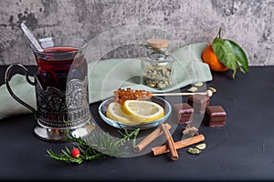 Hot fruit tea with lemon on the dark surface