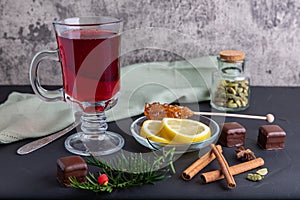 Hot fruit tea with lemon on the dark surface, copy space