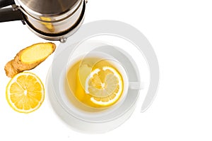 Hot ginger lemon tea in cup and filter jar