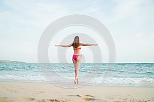 Hot girl wearing pink bikini on the summer beach