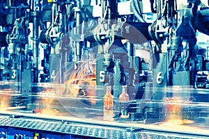 Hot glass bottles on glass production line