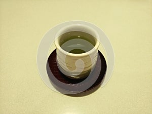 Hot Green tea/Japanese tea.Traditional herbal green tea in ceramic cup on white background. Healthy Drinks Concept