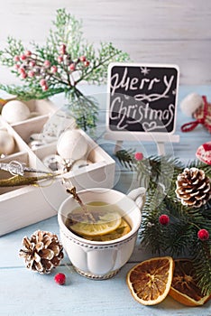 Hot green tea with lemon on a wooden table