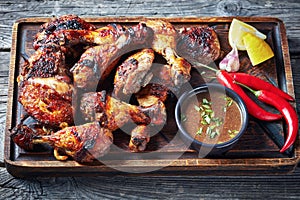 Hot Grilled Jamaican Jerk Chicken on a board photo