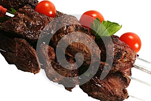 Hot grilled meat on skewer over white