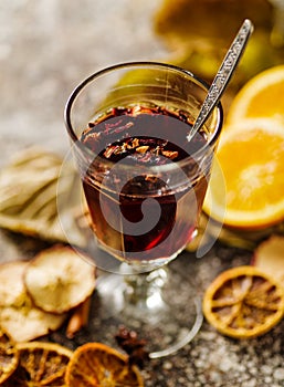 Hot grog in a glass on a table with dried fruits photo