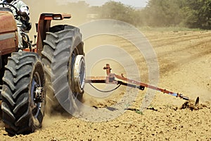 Hot heat summer sun ploughing fields in Kwazulu Natal South Africa, dusty movement blur, tractors, machinery photo